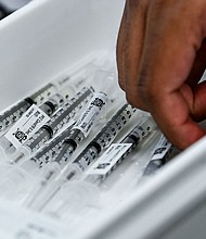 Pharmacy student Jason Rodriguez prepares Pfizer vaccines at the Christine E. Lynn Rehabilitation Center in Miami, Florida on April.
Mandatory Credit:	CHANDAN KHANNA/AFP/Getty Images