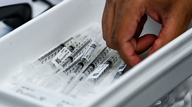 Pharmacy student Jason Rodriguez prepares Pfizer vaccines at the Christine E. Lynn Rehabilitation Center in Miami, Florida on April.
Mandatory Credit:	CHANDAN KHANNA/AFP/Getty Images