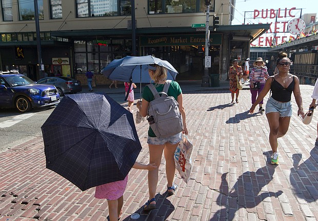 The extreme heat wave in the Northwest is beginning to subside in Seattle and Portland, Oregon, but millions remain under heat alerts. Pictured, people during a heat wave hitting the Pacific Northwest, on June 27, in Seattle.
Mandatory Credit:	John Froschauer/AP