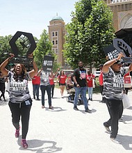 LaTosha Brown, front left, and Cliff Albright, co-founders of the Black Voters Matter Freedom Ride for Voting Rights, lead a short rally into Richmond’s Monroe Park from the caravan of buses that stopped in Richmond last Friday enroute to Washington.