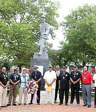 Members of the Astoria Beneficial Club honor the legacy of Bill “Bojangles” Robinson during its annual commemoration held last Saturday at the statue of Mr. Robinson at Leigh and Adams streets in Jackson Ward. The men’s club put the statue in place in 1973 to recognize Mr. Robinson, a Richmond native who rose to international acclaim as a tap dancer and entertainer, because of his impact on his hometown. In 1933, Mr. Robinson purchased a traffic light for $1,400 to be placed at the intersection where his statue now stands after witnessing the danger faced by African-American children trying to cross the busy street. During his lifetime, Mr. Robinson worked for racial equality and civil rights, including more equitable treatment of Black soldiers during World War II and more diverse police departments.