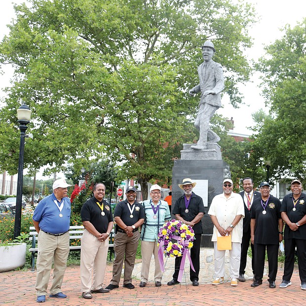 Members of the Astoria Beneficial Club honor the legacy of Bill “Bojangles” Robinson during its annual commemoration held last Saturday at the statue of Mr. Robinson at Leigh and Adams streets in Jackson Ward. The men’s club put the statue in place in 1973 to recognize Mr. Robinson, a Richmond native who rose to international acclaim as a tap dancer and entertainer, because of his impact on his hometown. In 1933, Mr. Robinson purchased a traffic light for $1,400 to be placed at the intersection where his statue now stands after witnessing the danger faced by African-American children trying to cross the busy street. During his lifetime, Mr. Robinson worked for racial equality and civil rights, including more equitable treatment of Black soldiers during World War II and more diverse police departments.