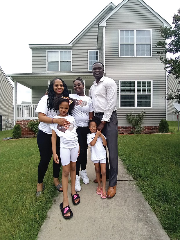 Travis L. and Latarsha F. Woods and their three children stand outside their home in Richmond’s Fulton neighborhood.