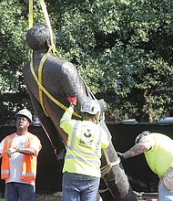 Workers from the state Department of General Services on Wednesday remove the 10-foot bronze statue of segregationist Harry F. Byrd Sr., a former Virginia governor and U.S. senator, from Capitol Square. During the General Assembly session earlier this year, the legislature approved a bill by Delegate Jay Jones of Norfolk authorizing its removal. No word yet on what will replace it.
