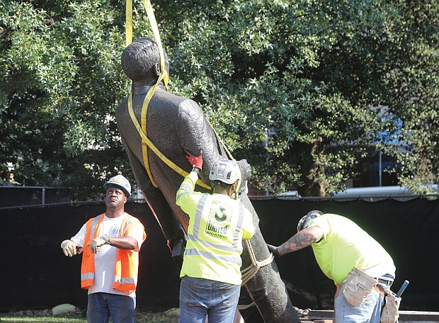 Workers from the state Department of General Services on Wednesday remove the 10-foot bronze statue of segregationist Harry F. Byrd Sr., a former Virginia governor and U.S. senator, from Capitol Square. During the General Assembly session earlier this year, the legislature approved a bill by Delegate Jay Jones of Norfolk authorizing its removal. No word yet on what will replace it.