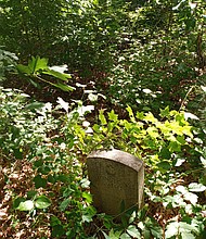 This headstone in the Smith family cemetery at 2511 Hopkins Lane in South Side is visible from the street. At least 45 people are believed to be buried at the site, which is said to have been a private burial ground for the enslaved from a nearby plantation.