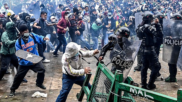 Demonstrators clash with riot police during a protest against a tax reform bill launched by Colombian President Ivan Duque, in Bogota, on April 28.
Mandatory Credit:	Juan Barreto/AFP via Getty Images