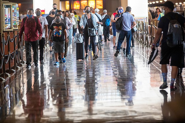Wearing face masks, people walk through Union Station in Los Angeles on June 29. California is one of the 24 states seeing an uptick in Covid-19 cases.
Mandatory Credit:	Francine Orr/Los Angeles Times/Getty Images