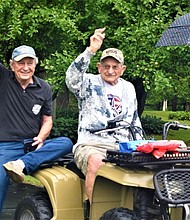 John Stanley Pioro (center) waves to participants in a car parade in celebration of his 100th birthday.
Mandatory Credit:	The Journal Times