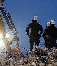 Search and rescue workers oversee an excavator dig through the rubble of the collapsed Champlain Towers South condo building.
Mandatory Credit:	Anna Moneymaker/Getty Images
