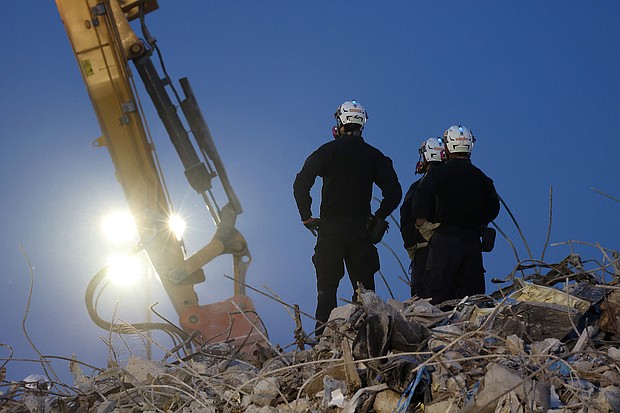 Search and rescue workers oversee an excavator dig through the rubble of the collapsed Champlain Towers South condo building.
Mandatory Credit:	Anna Moneymaker/Getty Images