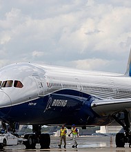 Boeing employees walk the Boeing 787-10 Dreamliner down towards the delivery ramp area at the company's facility in South Carolina after conducting its first test flight in 2017. On July 13 Boeing disclosed a new issue with the jet, which has been dogged with problems since August.
Mandatory Credit:	Mic Smith/AP