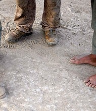 A U.S. Marine (C) talks through his interpreter (L) to an Afghan man during a patrol on July 6, 2009 in Mian Poshteh, Afghanistan.
Mandatory Credit:	Joe Raedle/Getty Images