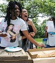 Sisterly soiree/Sisters Nylah Doswell from left, Nyaja Plummer and Nasya Doswell share a laugh and enjoy pizza during a Daughters of the King Soiree last Saturday in Byrd Park. The group meets monthly in various locations and is a ministry and mentorship program for young women sponsored by The Church of God in Richmond located in South Side.