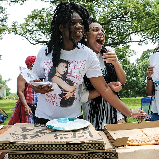 Sisterly soiree/Sisters Nylah Doswell from left, Nyaja Plummer and Nasya Doswell share a laugh and enjoy pizza during a Daughters of the King Soiree last Saturday in Byrd Park. The group meets monthly in various locations and is a ministry and mentorship program for young women sponsored by The Church of God in Richmond located in South Side.