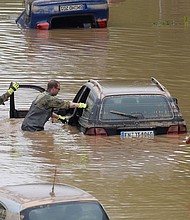 Soldiers of the German armed forces Bundeswehr search for flood victims in submerged vehicles on the federal highway B265 in Erftstadt, western Germany, on July 17, after heavy rains hit parts of the country, causing widespread flooding and major damage.
Mandatory Credit:	Sebastien Bozon/AFP/Getty Images