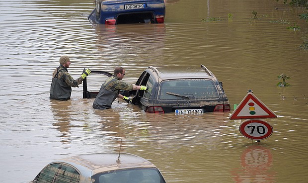 Soldiers of the German armed forces Bundeswehr search for flood victims in submerged vehicles on the federal highway B265 in Erftstadt, western Germany, on July 17, after heavy rains hit parts of the country, causing widespread flooding and major damage.
Mandatory Credit:	Sebastien Bozon/AFP/Getty Images