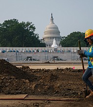 Workers repair a park near the Capitol in Washington on July 21 as senators struggle to reach a compromise over how to pay for nearly $1 trillion in public works spending, a key part of President Joe Biden's agenda.
Mandatory Credit:	J. Scott Applewhite/AP