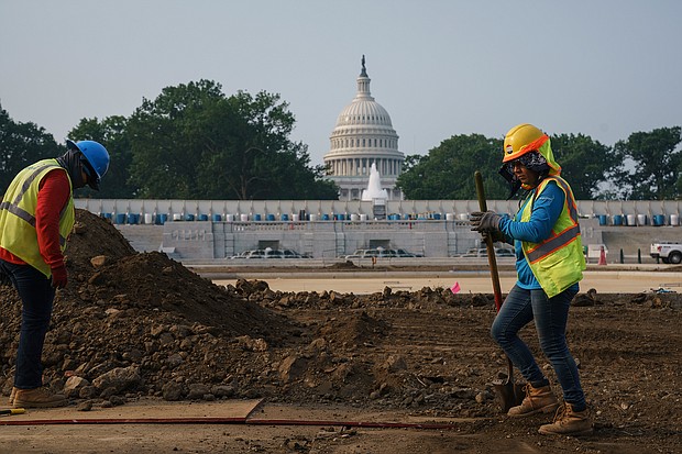 Workers repair a park near the Capitol in Washington on July 21 as senators struggle to reach a compromise over how to pay for nearly $1 trillion in public works spending, a key part of President Joe Biden's agenda.
Mandatory Credit:	J. Scott Applewhite/AP
