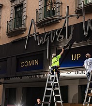 Workers replace signs at the August Wilson Theatre in New York City on June 29. More than a year into a global pandemic and amid an international social justice movement, Broadway, it seems, is changing. Seven new plays joining this fall's lineup are written by Black playwrights.
Mandatory Credit:	Bryan Anselm/For The Washington Post/Getty Images