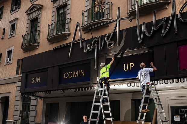 Workers replace signs at the August Wilson Theatre in New York City on June 29. More than a year into a global pandemic and amid an international social justice movement, Broadway, it seems, is changing. Seven new plays joining this fall's lineup are written by Black playwrights.
Mandatory Credit:	Bryan Anselm/For The Washington Post/Getty Images