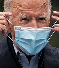 Then-Democratic presidential nominee Joe Biden puts on a face mask while speaking to reporters at a voter mobilization center on October 26, 2020, in Chester, Pennsylvania.
Mandatory Credit:	Drew Angerer/Getty Images	Then-Democratic presidential nominee Joe Biden puts on a face mask while speaking to reporters at a voter mobilization center on October 26, 2020, in Chester, Pennsylvania.
Mandatory Credit:	Drew Angerer/Getty Images