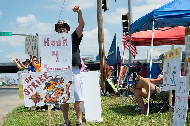 Ron Sadler, a Frito-Lay employee for 32 years, raises a fist as drivers show support for the union strike on July 20.
Mandatory Credit:	Evert Nelson/USA Today Network