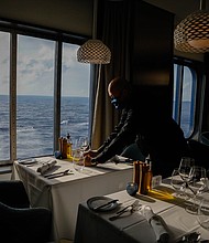 An employee sets a table at Cyprus Restaurant on the Celebrity Edge cruise ship on June 27.
Mandatory Credit:	Eva Marie Uzcategui/Bloomberg/Getty Images