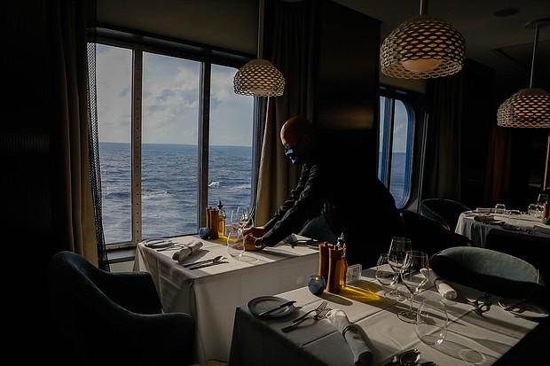 An employee sets a table at Cyprus Restaurant on the Celebrity Edge cruise ship on June 27.
Mandatory Credit:	Eva Marie Uzcategui/Bloomberg/Getty Images