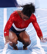 Simone Biles of Team United States stumbles upon landing after competing in vault during the women's team final on day four of the Tokyo 2020 Olympic Games at Ariake Gymnastics Centre.
Mandatory Credit: Jamie Squire/Getty Images