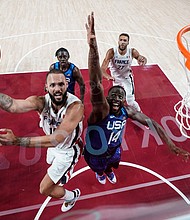 France's Evan Fournier goes for the basket past USA's Draymond Green at the Saitama Super Arena in Saitama, Japan, on July 25.
Mandatory Credit: Eric Gay/AFP/Getty Images