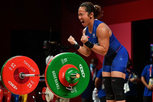 Philippines' Hidilyn Diaz reacts while competing in the women's 55kg weightlifting competition during the Tokyo 2020 Olympic Games.
Mandatory Credit:	Vincenzo Pinto/AFP/Getty Images