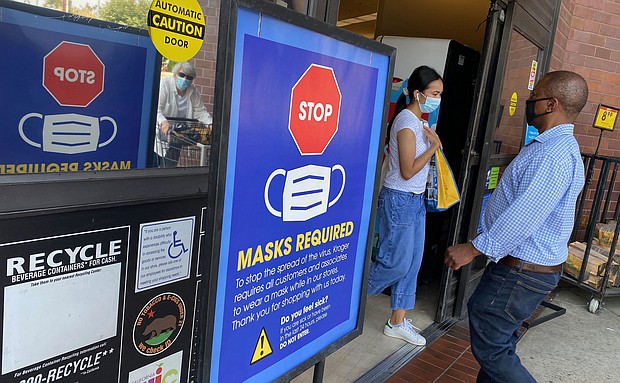 People shop at a grocery store enforcing the wearing of masks in Los Angeles on July 23. Top federal health officials have debated whether to issue new guidance on masks and are close to announcing their decision as the Delta variant fuels new outbreaks in the United States.
Mandatory Credit:	Chris Delmas/AFP/Getty Images