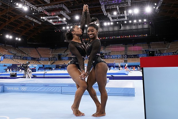 Simone Biles, of the United States, right, poses for pictures with teammate Jordan Chiles after an artistic gymnastics practice session at the 2020 Summer Olympics in Tokyo.
Mandatory Credit:	Gregory Bull/AP