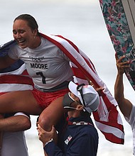 US's Carissa Moore celebrates after winning the women's Surfing gold medal final at the Tsurigasaki Surfing Beach, in Chiba, on July 27, during the Tokyo 2020 Olympic Games.
Mandatory Credit: Yuki Iwamura/AFP/Getty Images