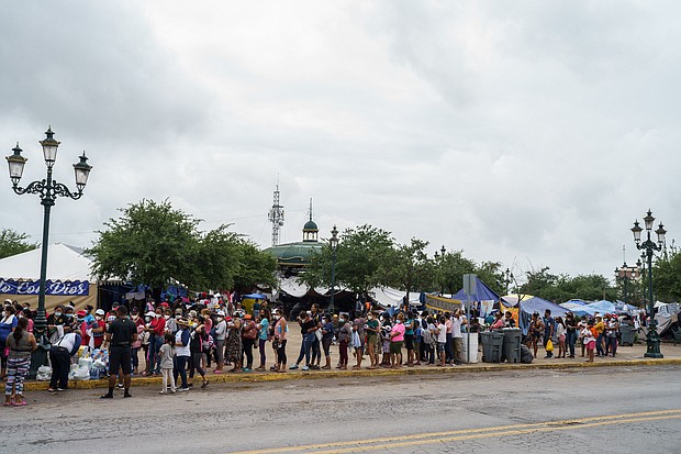 Migrants who were sent back to Mexico under Title 42 wait in line for food and supplies in a camp across the US-Mexico border in Reynosa, Tamaulipas, Mexico on July 10.
Mandatory Credit:	Paul  Ratje/AFP/Getty Images