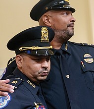 Sgt. Aquilino Gonell, left, and Officer Harry Dunn of the U.S. Capitol Police show support for one another following their emotional testimony Tuesday before the House select committee investigating the Jan. 6 attack on the U.S. Capitol.
