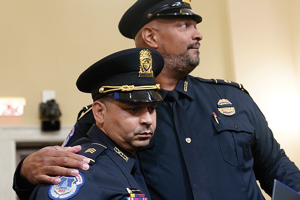 Sgt. Aquilino Gonell, left, and Officer Harry Dunn of the U.S. Capitol Police show support for one another following their emotional testimony Tuesday before the House select committee investigating the Jan. 6 attack on the U.S. Capitol.