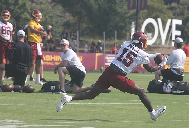 Steven Sims Jr., a wide receiver for the Washington Football Team, stretches to make the catch during practice Wednesday morning at the team’s Richmond training camp at 2401 W. Leigh St. Fans were on hand for the session.