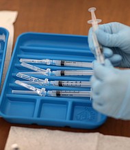 A healthcare worker prepares Moderna COVID-19 vaccines at a clinic on May 20, 2021, in Immokalee, Florida.
Mandatory Credit:	Joe Raedle/Getty Images