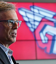 Cleveland baseball team owner Paul Dolan speaks to the media July 23 as the new Cleveland Guardians logo is displayed.