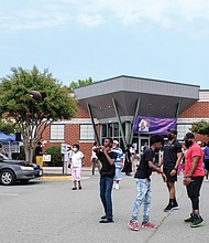 Cityscape: Slices of life and scenes in Richmond: Richmond residents gather outside the refurbished Annie Marie Giles Community Resource & Training Center in Shockoe Valley for the grand reopening celebration last Saturday. Born as a school and used for several years as a homeless shelter, the building is now to host programs that benefit residents in the East View community and the Whitcomb and Mosby public housing communities located on the hills above Shockoe Valley.