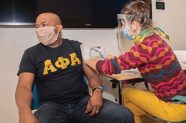 This Alpha Phi Alpha Fraternity member is among the thousands of people who have been vaccinated at various community events by volunteers with the Virginia Commonwealth University Vaccination Corps, which was started in January. Here, Marissa Mackiewicz, a student at the VCU School of Pharmacy and corps member, administers a vaccine at the VCU Health Hub at 25th in