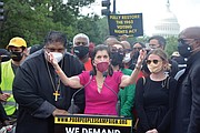 Luci Baines Johnson, daughter of former President Lyndon B. Johnson, urges the crowd to continue to fight for voting rights and social justice. Standing with her is the Rev. William J. Barber II, co-chair of the Poor People’s Campaign.