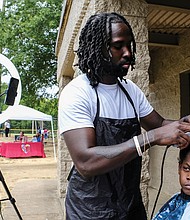 Getting ready for school/The Broad Rock Sports Complex on Old Warwick Road in South Side became a festival of sorts last Saturday as the venue for RPS Summer Fest. The event, sponsored by Richmond Public Schools, featured games, entertainment, food and information on how to enroll students in school this fall along with other community resources. Barber Alonzo Bosher trims the braids of Tyler Sims, 5, as he gets ready for class in September. This was the second Summer Fest hosted by the school system. The first was held July 24 at Martin Luther King Jr. Middle School.