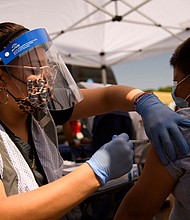 A 12-year-old receives a first dose of the Pfizer Covid-19 vaccine at a mobile vaccination clinic during a back to school event in Los Angeles.
Mandatory Credit:	Patrick T. Fallon/AFP/Getty Images