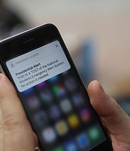 A test of the wireless emergency alert system is displayed on an iPhone.
Mandatory Credit:	Andrew Harrer/Bloomberg/Getty Images