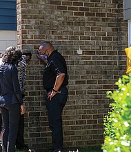 Police Chief Gerald Smith consoles the mother of one of the victims injured in gun violence April 27 at the Belt Atlantic Apartments in South Side. Sharnez Hill, 30, and her 3-month-old daughter were killed in the shooting and three others, ages 29, 15 and 11, were wounded. Chief Smith marched with scores of people attending a rally sponsored by Men in Action on May 1 calling for an end to the violence. The group marched from George Wythe High School to the apartment complex, where Chief Smith tried to comfort the mother.