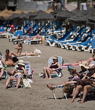 Tourists are seen sunbathing in Marbella, Spain, in June.
Mandatory Credit:	Jorge Guerrero/AFP via Getty Images