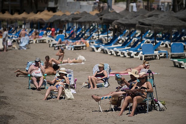 Tourists are seen sunbathing in Marbella, Spain, in June.
Mandatory Credit:	Jorge Guerrero/AFP via Getty Images